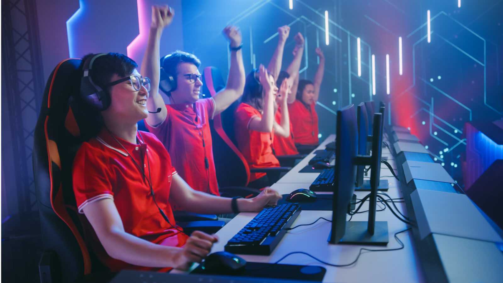esport-team-pro-gamers-play-video-game-championship-arena-happy-team-wins-round-celebrates-with-highfives-cyber-games-online-broadcasting-tournament-event